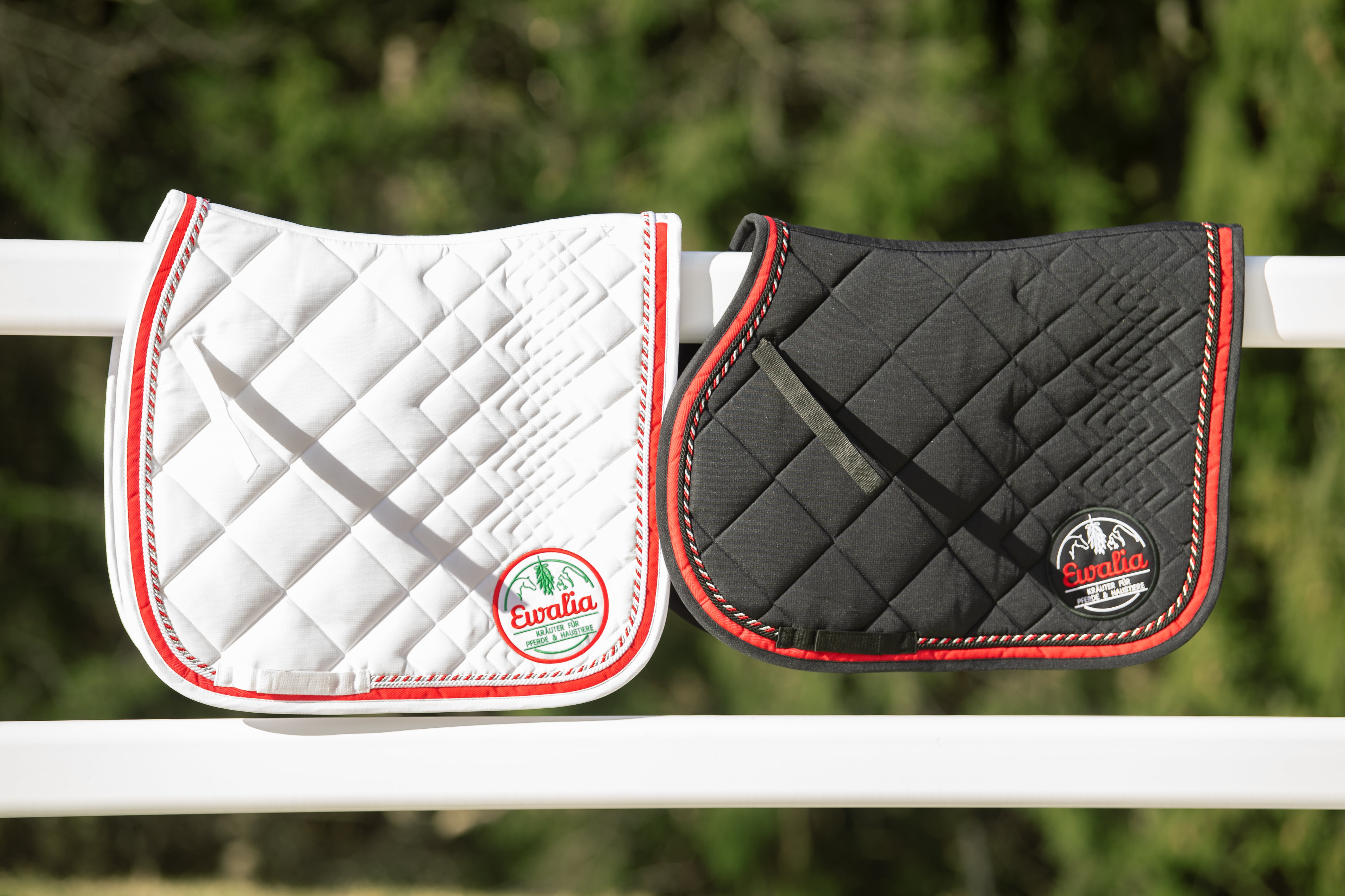 black and white saddle pad hanging next to each other